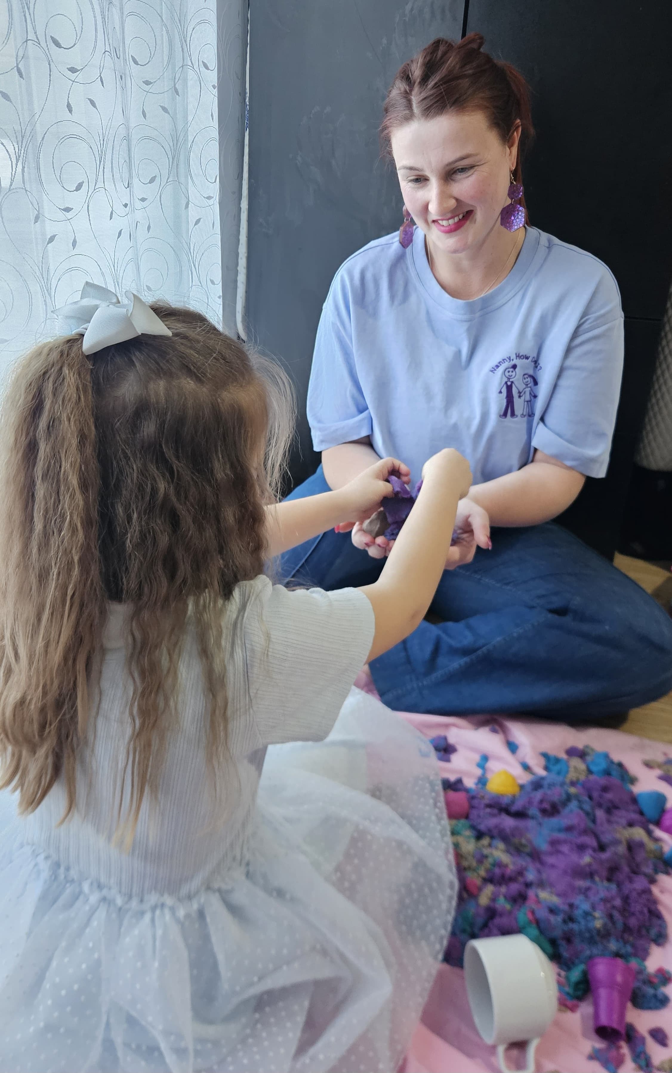 Antonia supporting a child through a calm, engaging moment.