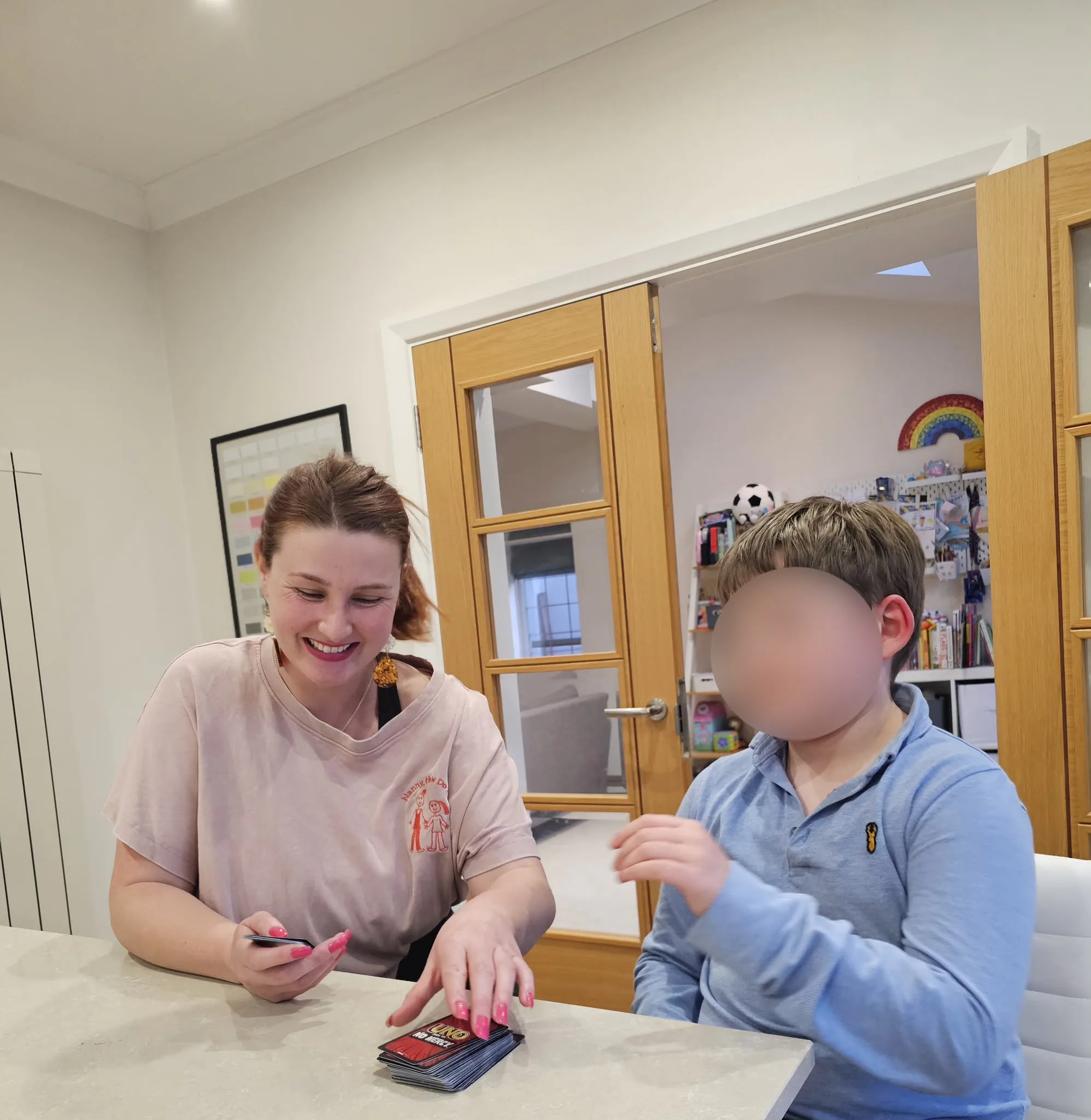 Antonia supporting children in a warm setting.
